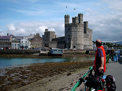 Cyclist looking across at Caernarfon castle